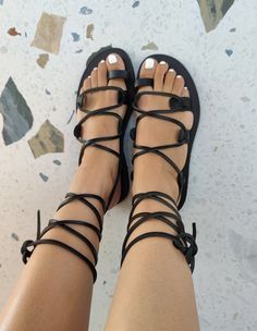 Greek Black Leather Sandals are made from 100% genuine Cretan leather in Greece. ❤ Description - 100% Greek Leather - 100% Handmade Sandals - The sole is lightweight and handmade with high-durable rubber. - Every pair of our leather sandals is unique. Small natural marks or light color irregularities are common in these types o shoes. These are absolutely physical, as no chemicals are used. People who wear handmade jewelry or accessories love that small imperfections.  - The sandals are availabl Black Ankle Tie Lace-up Sandals For Vacation, Adjustable Cross-tied Sandals For Beach, Leather Ankle Tie Lace-up Sandals For Beach, Leather Lace-up Ankle Tie Sandals For Beach, Leather Toe Loop Lace-up Sandals For Beach, Leather Toe Loop Lace-up Sandals For Vacation, Leather Ankle Tie Lace-up Sandals For Vacation, Cross-tied Sandals With Ankle Strap For Vacation, Leather Lace-up Ankle Tie Sandals