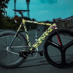 a yellow and black bike is parked on the street