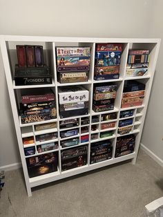 a book shelf filled with lots of books and video games