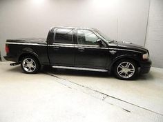 a black pickup truck parked in a garage