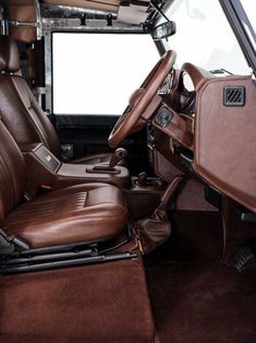 the interior of a vehicle with brown leather seats