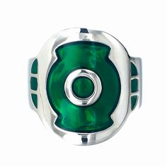 a green and silver ring with an oval design on the center, set against a white background