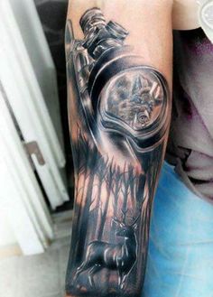 a person with a tattoo on their arm holding a clock and an eagle in the background