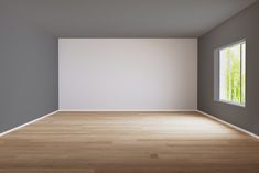 an empty room with wood floors and white walls