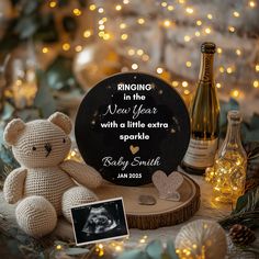 a teddy bear sitting on top of a wooden table next to bottles and lights in the background