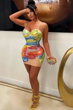 a woman in a colorful dress posing for the camera