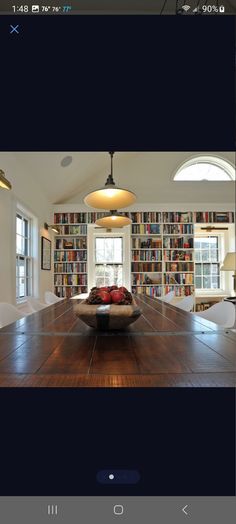 a room with bookshelves and a couch in the middle is shown on an iphone screen