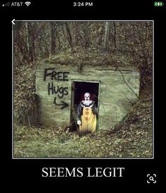 there is a creepy clown in the door of a building that says free hugs, seems legit