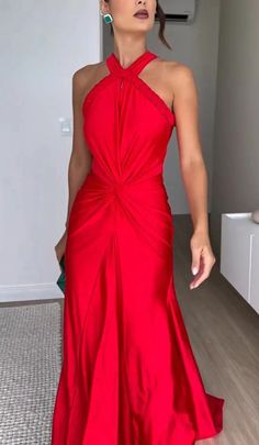 a woman in a red dress posing for the camera with her hand on her hip