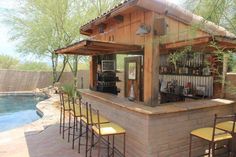 an outdoor bar next to a swimming pool