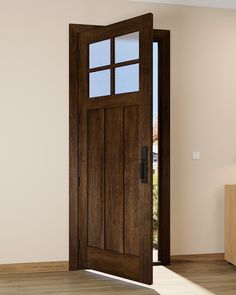 an open wooden door in the middle of a room with wood flooring and white walls