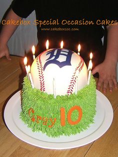 a birthday cake with candles on top of it that is decorated like a baseball and the number 10