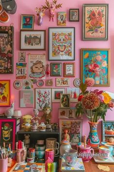 there are many pictures on the wall and vases with flowers in them, along with other items