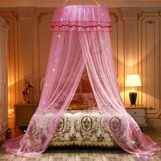 a bed with a pink canopy over it