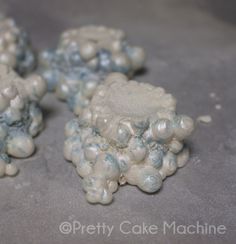 some white and blue rocks on a gray surface