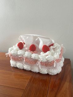 a cake that is sitting on top of a wooden table with white and pink trim