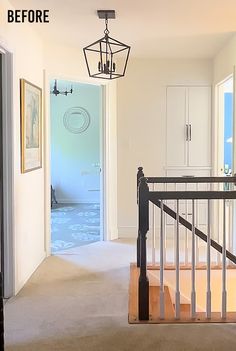 an open door leading to a hallway with white walls and carpeted flooring on either side