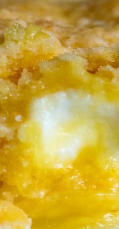 a close up view of some food that is yellow and has white stuff on it