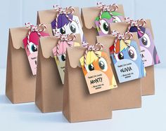 four little pony bags with tags attached to them