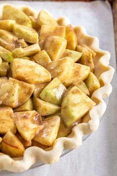 a pie with apples in it sitting on top of a table