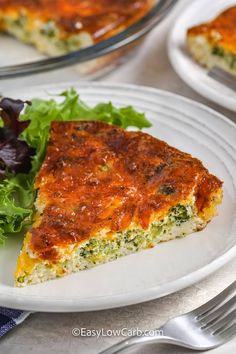 a slice of quiche on a plate with lettuce