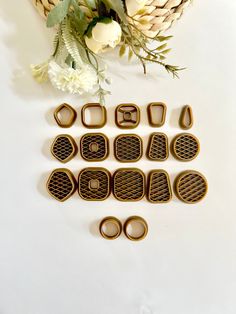 some cookie cutters sitting on top of a table next to flowers and a basket