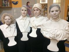 three women in white and black outfits posing for the camera with their faces painted like human bodies