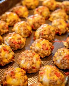 baked meatballs with cheese and tomato sauce on a baking sheet ready to be eaten