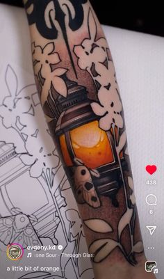 a person with a tattoo on their arm and the image of a lantern is shown