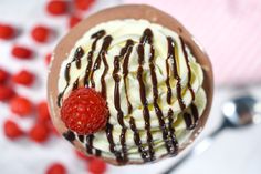 a chocolate dessert with whipped cream and raspberries