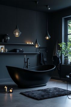 a black bath tub sitting in a bathroom next to a window with candles on it