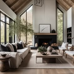 a living room filled with furniture and a fire place in the middle of a room