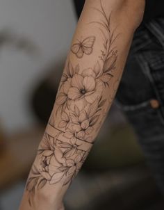 a woman with a flower tattoo on her arm