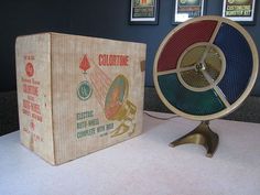 a wooden box sitting next to a spinning toy