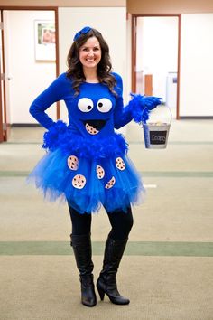 a woman dressed as cookie monster holding a cup