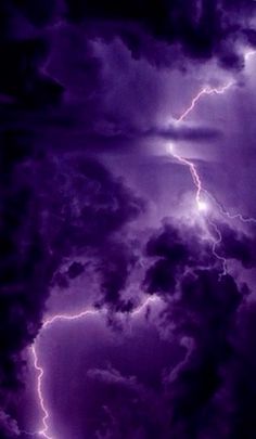 the sky is filled with purple clouds and lightning