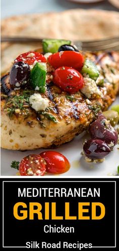 grilled chicken with tomatoes, cucumbers and olives on a white plate