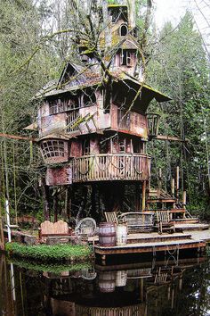 an old wooden house sitting on top of a body of water