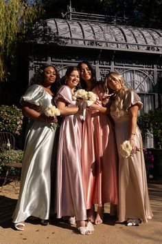 four bridesmaids pose for a photo in front of the gazebo