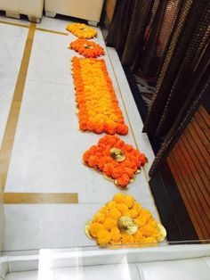 flowers laid out on the floor in front of a door