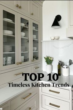 a kitchen with white cabinets and gold handles on the top 10 trimless kitchen items