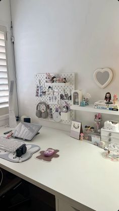 a white desk topped with lots of clutter