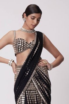 Black pre-draped lehenga saree with all over quad mirror embellishments and cutdana highlights. Paired with a strap sleeves sweetheart neck mirror jaal embroidered blouse. - Aza Fashions Glamorous Pre-draped Saree For Reception And Navratri, Glamorous Fitted Pre-draped Saree With Dupatta, Glamorous Saree Set With Sheer Dupatta, Elegant Pre-draped Saree With Motifs For Navratri, Glamorous Designer Pre-draped Saree For Navratri, Glamorous Wedding Pre-draped Saree With Pallu, Glamorous Designer Sharara With Traditional Drape, Glamorous Sharara With Unstitched Blouse For Diwali, Glamorous Sharara With Traditional Drape For Festivals