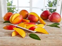 several pieces of fruit on a wooden table