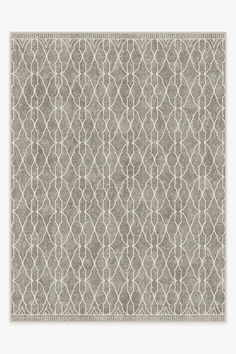 a gray rug with an intricate design on the bottom, and a white border around it