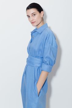 Wide waist Separate band to fit on waist or hips Shirt Collar Centre front hidden button closures Inseam pockets Full-length sleeves with pleats and button cuffs Binded mini-overlock seams Colour: Empyrean Blue One size fits all (S/M/L) 100% Premium LinenMADE IN NEW YORK CITY Collared Blue Jumpsuits And Rompers For Spring, Blue Collared Jumpsuits And Rompers For Spring, Relaxed Fit Collared Jumpsuits And Rompers For Work, Elegant Long Sleeve Jumpsuits And Rompers With Pockets, Relaxed Fit Long Sleeve Jumpsuits And Rompers, Chic Long Sleeve Cotton Jumpsuits And Rompers, Chic Long Sleeve Cotton Jumpsuit, Spring Long Sleeve Jumpsuits And Rompers For Daywear, Long Sleeve Jumpsuits And Rompers For Spring Daywear