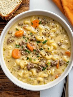 a white bowl filled with pasta and meat soup