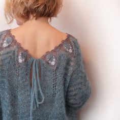 the back of a woman's sweater with sequins on it