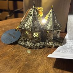 a wooden table topped with two small houses