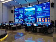 a large display in the middle of a building with multiple monitors on it's sides